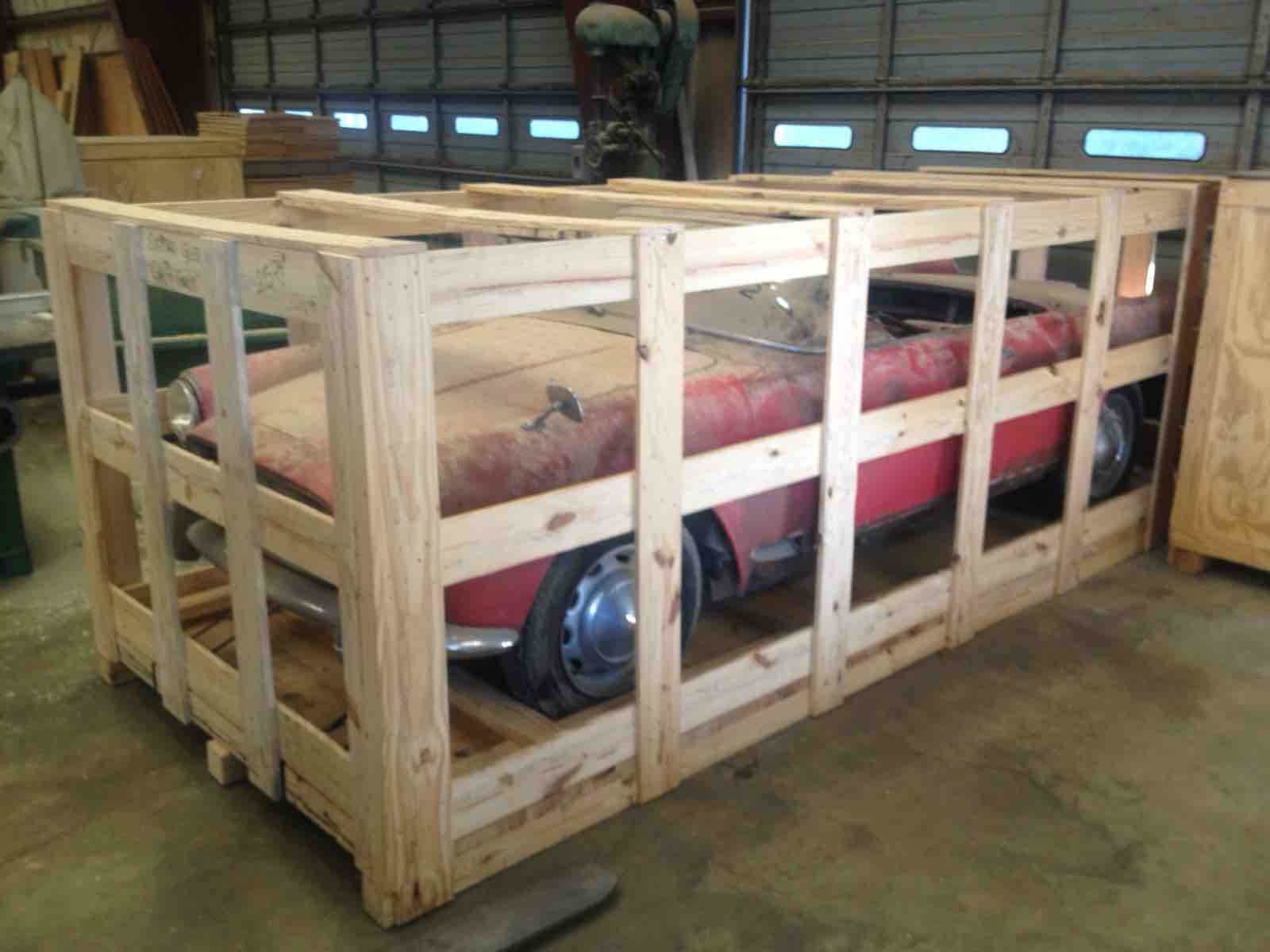 Classic car inside an open wooden crate