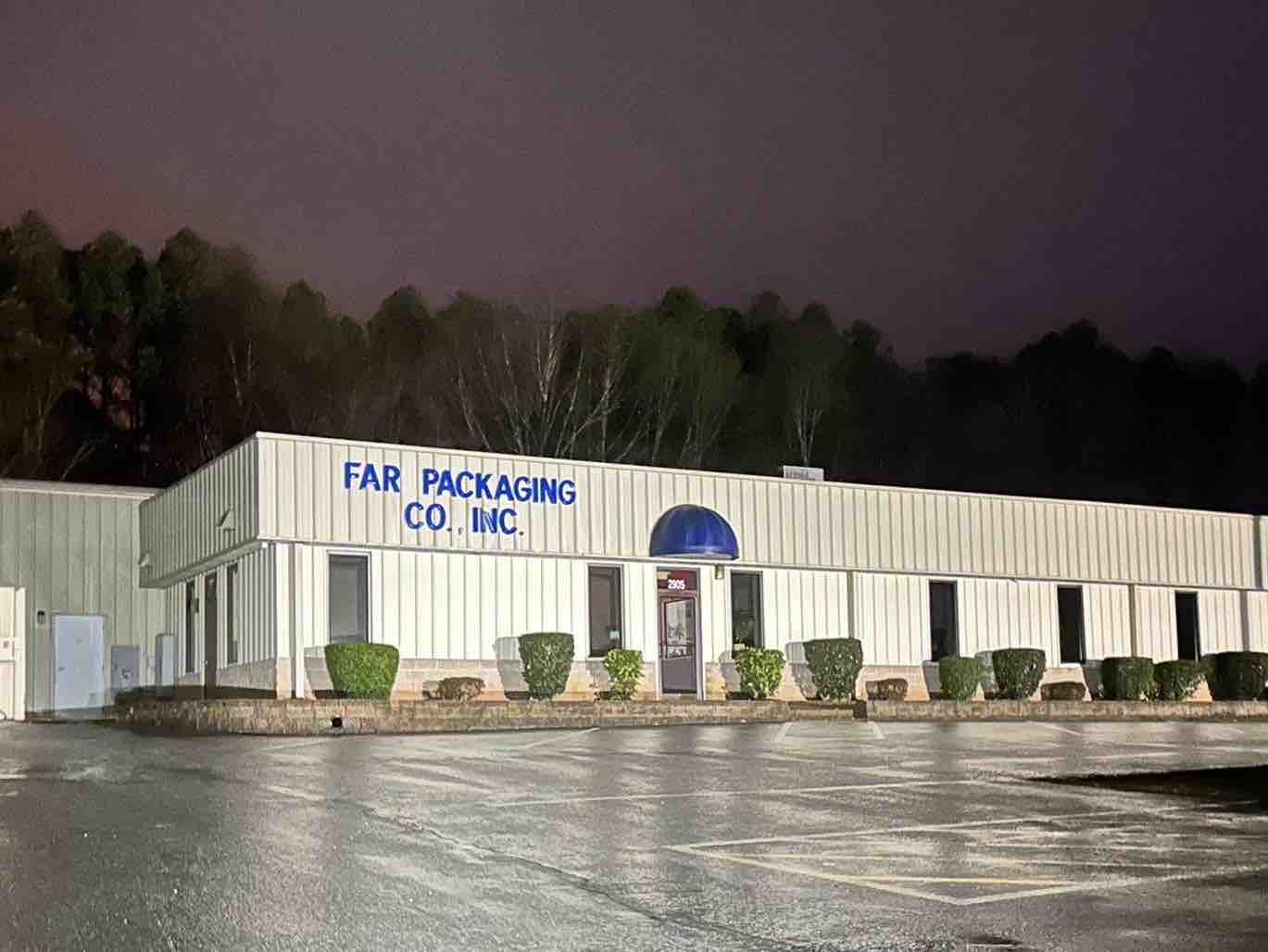 The Far Packaging Company, Inc. building and sign at night